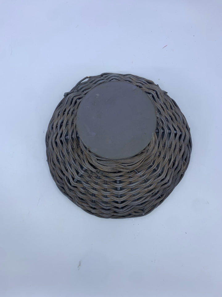 GRAY WOVEN METAL FOOTED BASKET.