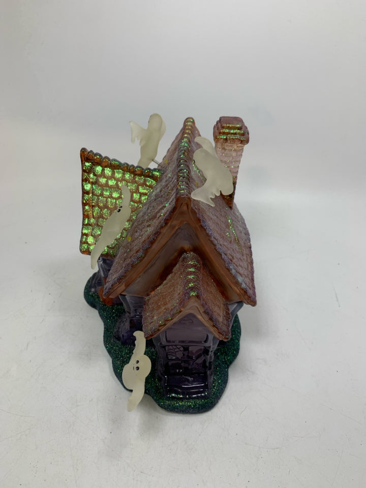 PLASTIC/RESIN PURPLE GHOST HAUNTED HOUSE W/ MUSIC/ FLSHING LIGHTS.