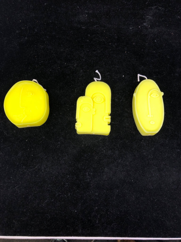 3 ABSTRACT FACE SHAPED CANDLES.