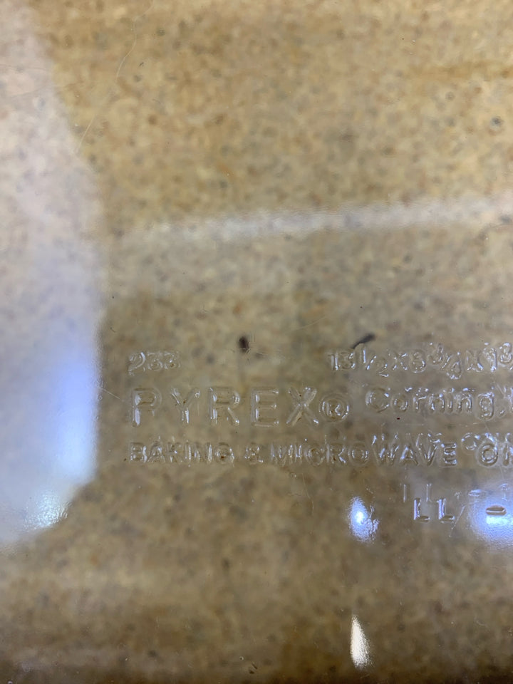 PYREX DISH W/WOVEN BASKET LEATHER HANDLES.