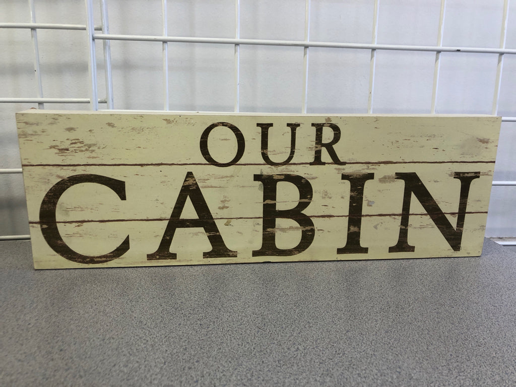 "OUR CABIN" CREAM DISTRESSED WOOD SIGN.
