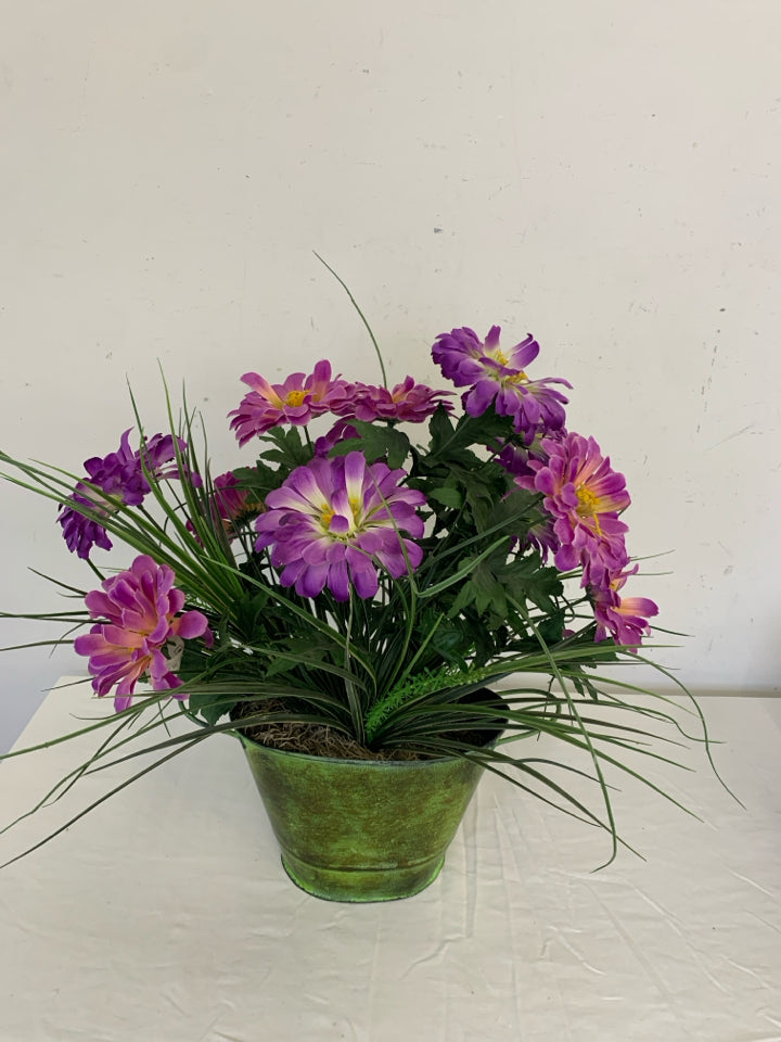 GREEN VASE W/PURPLE FAUX FLOWERS.