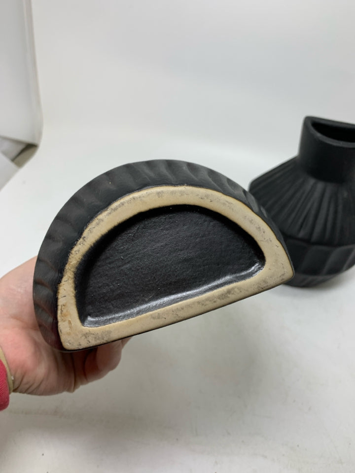 2 BLACK CERAMIC ONE FLAT SIDE VASES.
