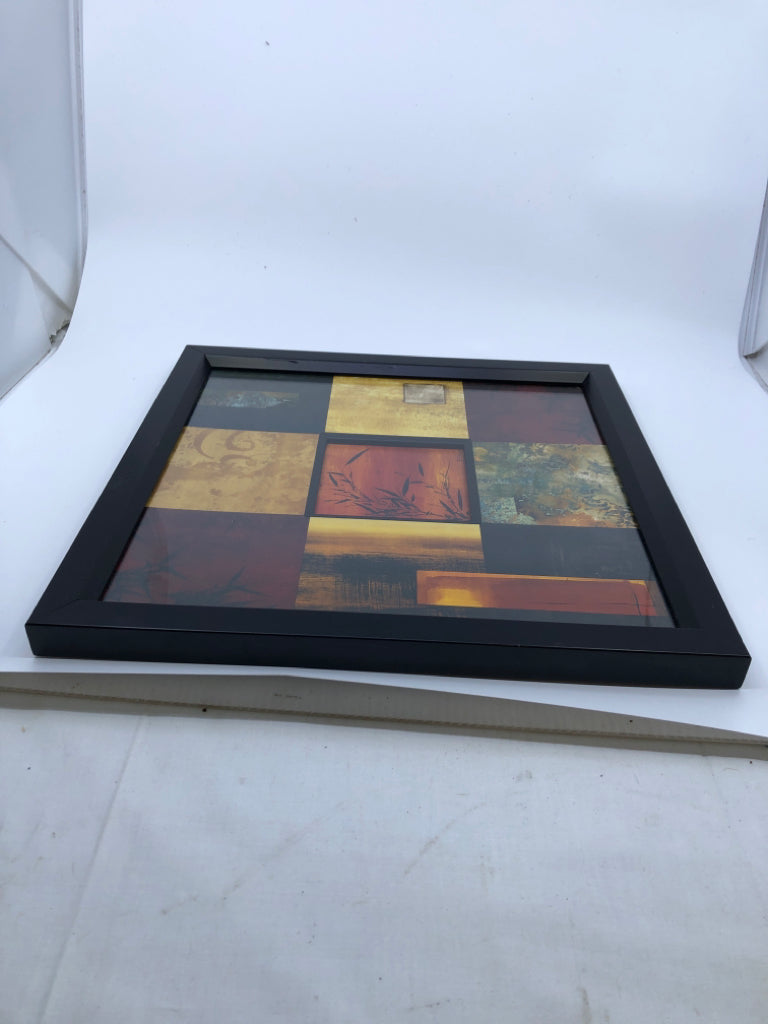 RED SQUARE PATTERN W BLACK LEAVES WALL ART IN BLACK FRAME.