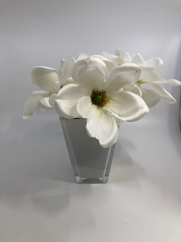 FAUX MAGNOLIA FLOWERS IN WHITE GLASS VASE.