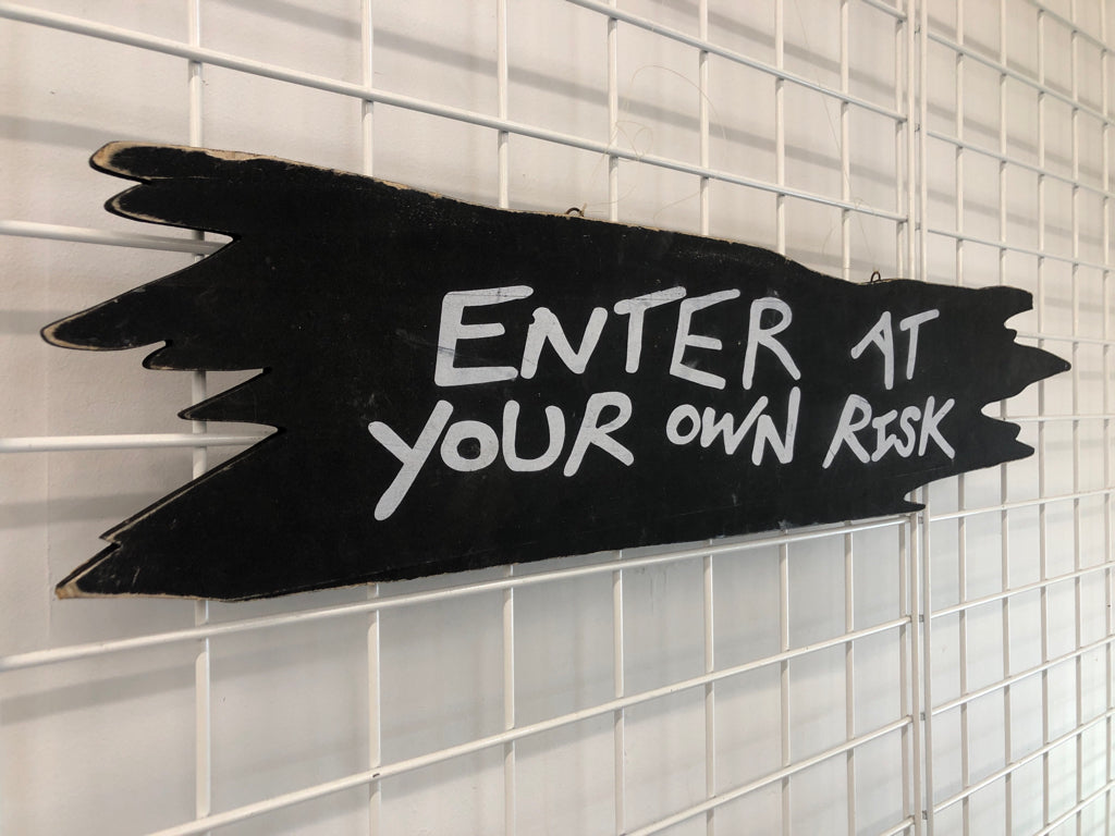 ENTER AT YOUR OWN RISK WOOD SIGN.