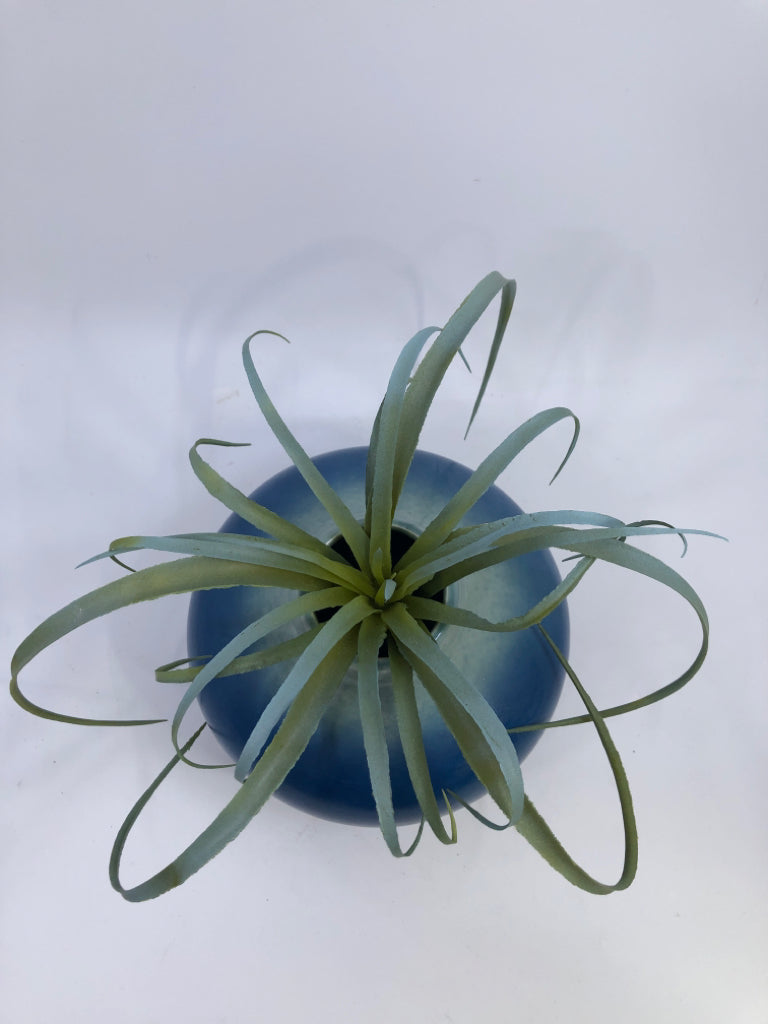 BLUE CERAMIC VASE W/ LIGHT COLORED NECK FAUX LEAVES.