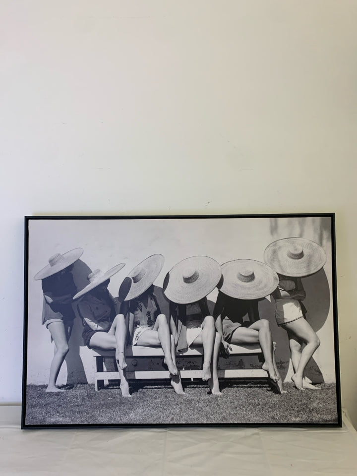 LADIES IN SUN HATS ON CHAIRS BLACK AND WHITE WALL HANGING.