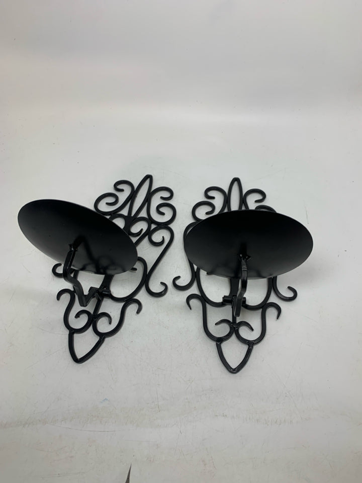 2 BLACK SCROLL FOLD DOWN PILLAR CANDLE HOLDERS.