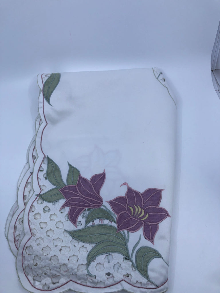 WHITE SQUARE TABLE CLOTH W/ PURPLE FLOWERS.