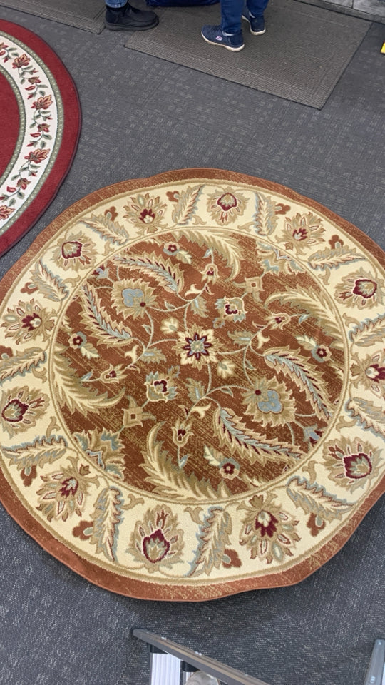 GOLDEN CIRCLE RUG W/LEAF DESIGNS.