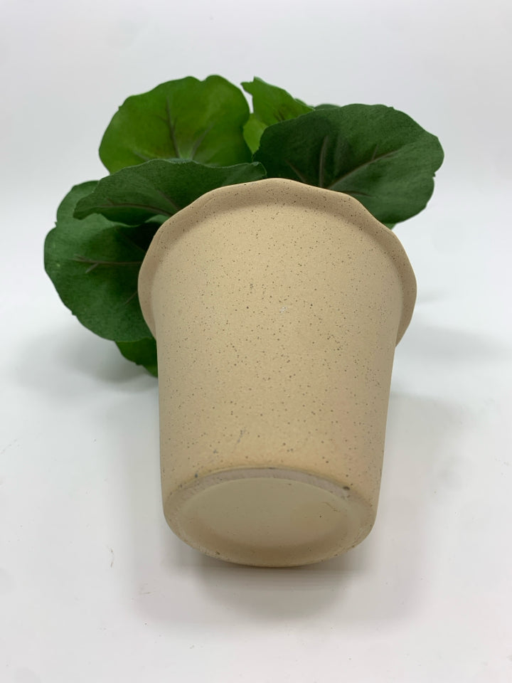 FAUX GERANIUM IN TAN POT.