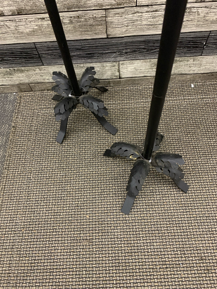 2 BLACK METAL FOOTED PILLAR CANDLE HOLDERS W/ LEAVES.