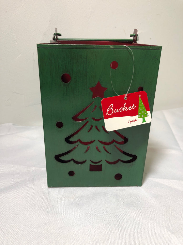 GREEN METAL PIERCED BAG CANDLE HOLDER W HANDLES.