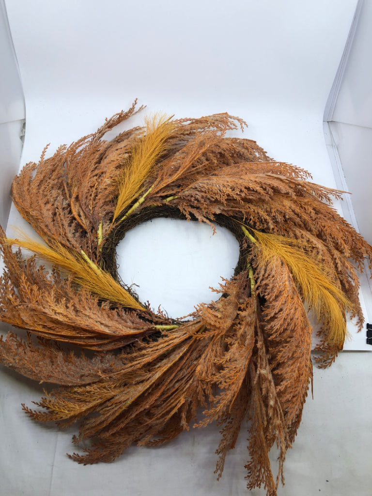 ORANGE FEATHER STYLE TWIG WREATH.