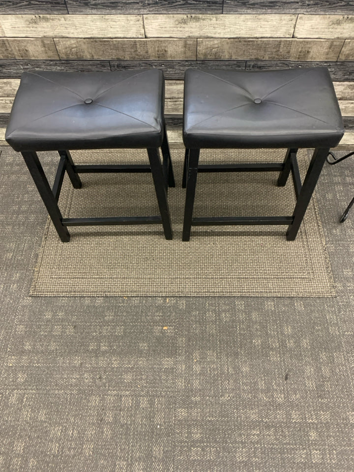 2 SADDLE BLACK FAUX LEATHER BAR STOOLS.