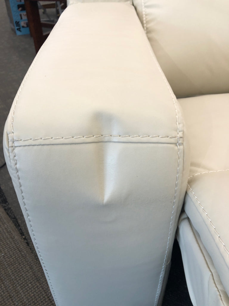 WHITE FAUX LEATHER RECLINING LOVE SEAT.