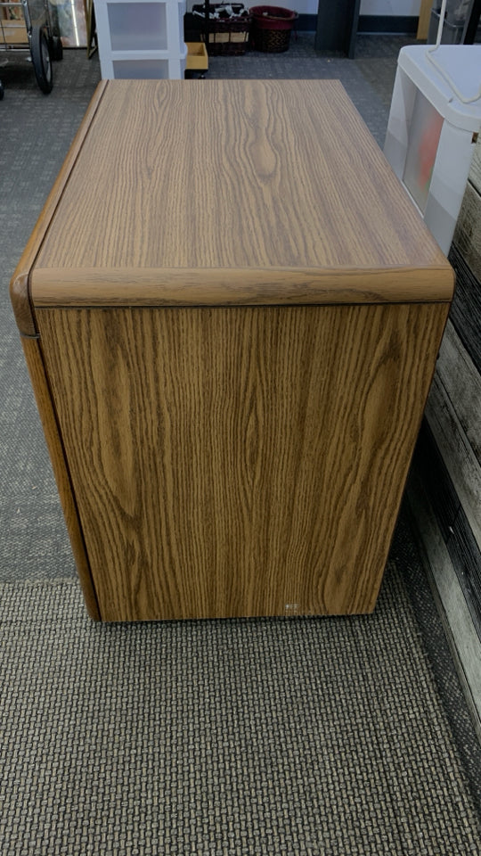 WOOD GRAIN TV STAND W/DOORS ON WHEELS.