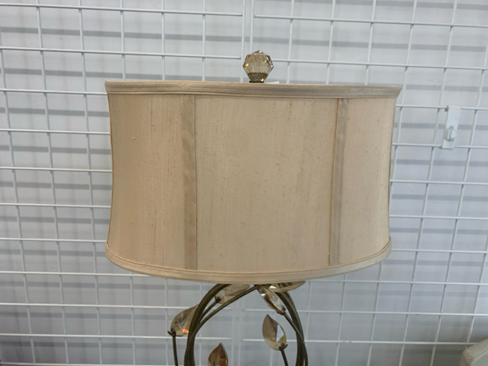 GOLD BASE LAMP W/CRYSTAL LEAVES AND CREAM SHADE.