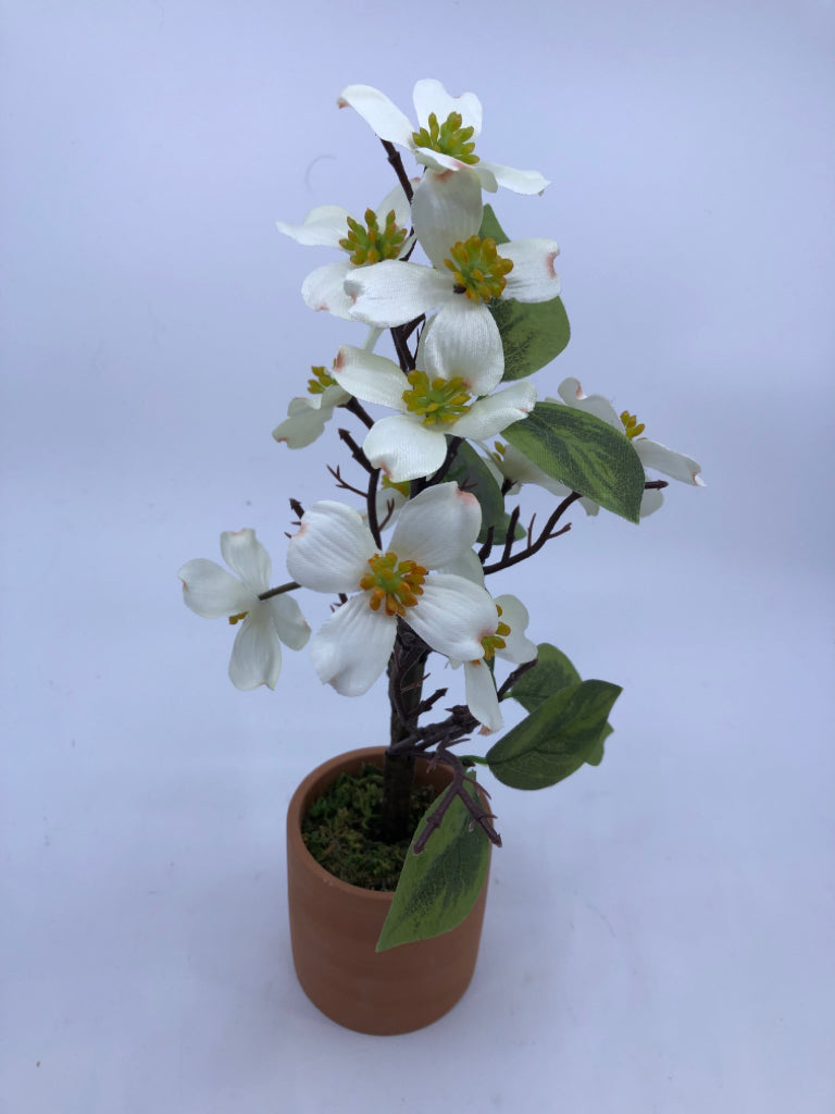 FAUX WHITE FLORAL IN TERRA COTTA PLANTER.