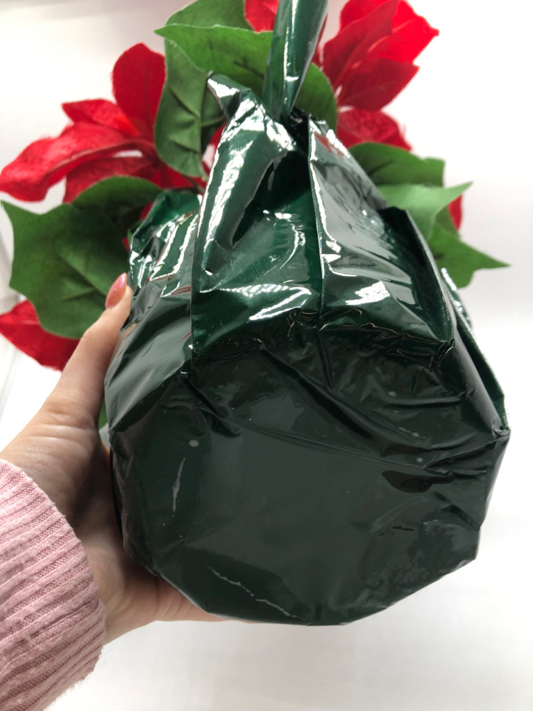 FAUX POINSETTIA IN GREEN WRAP POT.
