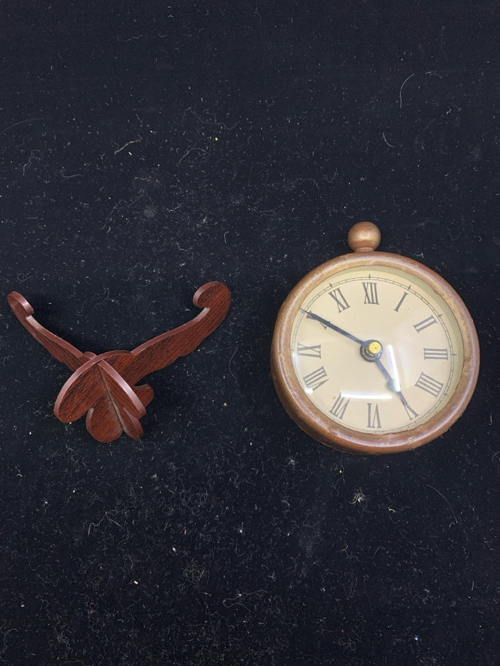 SMALL RUSTIC DECORATIVE CLOCK ON STAND.