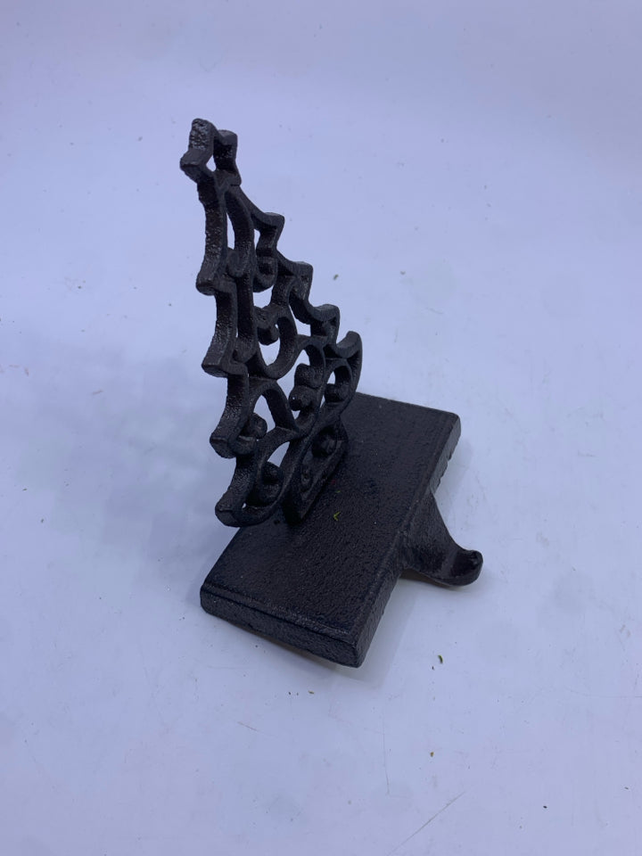 BROWN METAL CUTOUT TREE STOCKING HOLDER.
