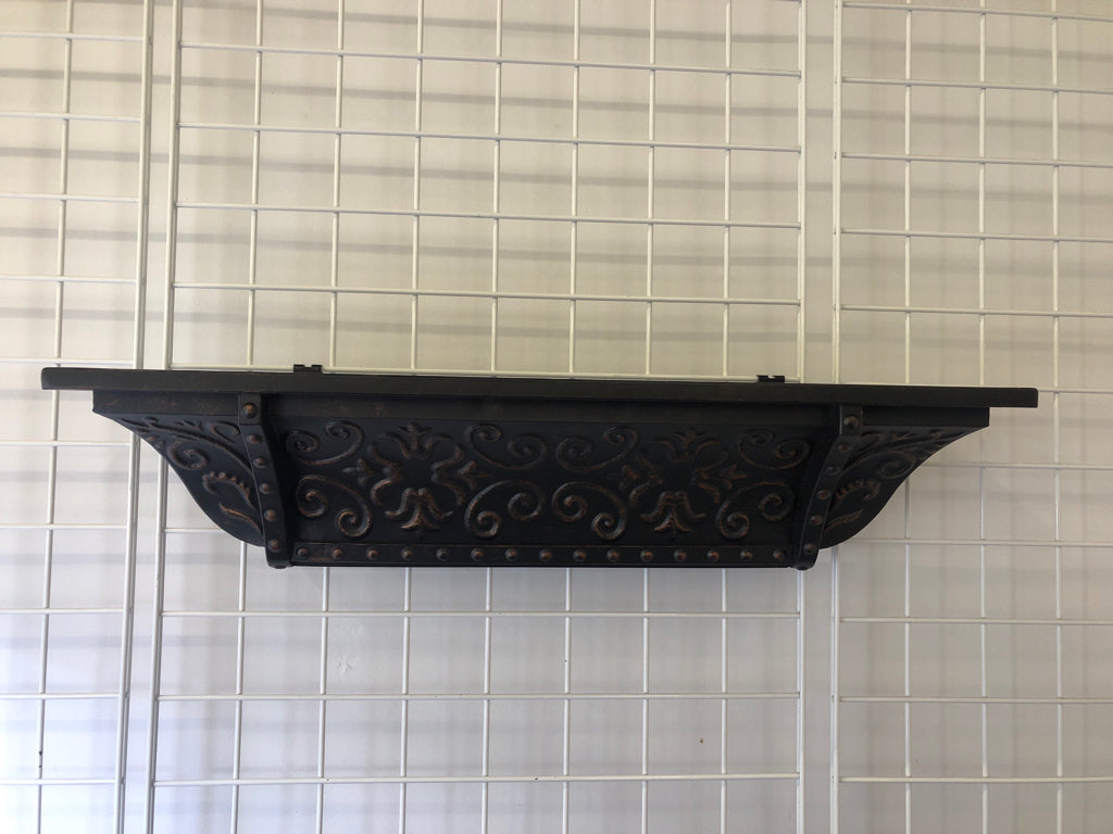 BLACK METAL SCROLL WALL SHELF W/ EMBOSSED DETAIL.