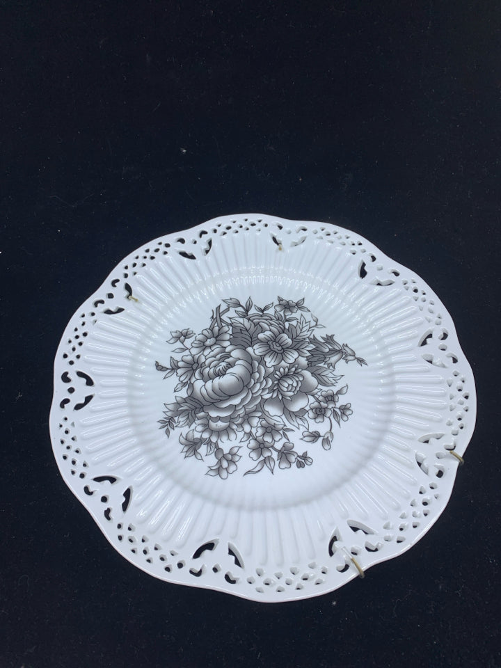 WHITE DECORATIVE PLATE W/BLACK FLOWERS.