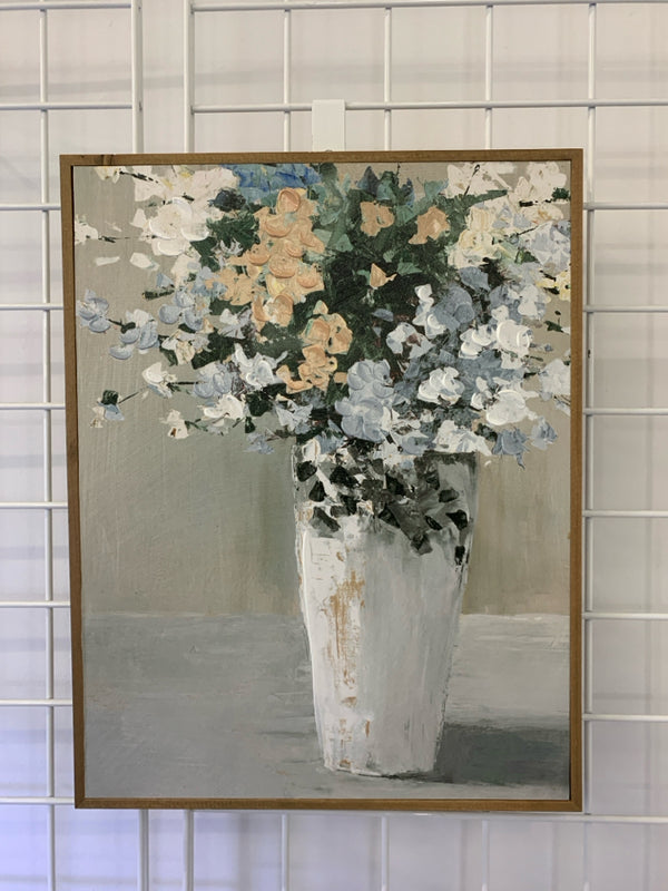 TEXTURED WHITE, TAN, BLUE, GREEN FLOWERS IN TALL WHITE VASE IN BROWN FRAME.
