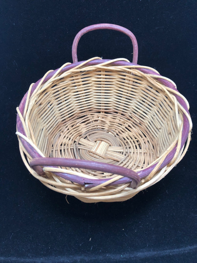 ROUND WOVEN BASKET W/PURPLE RIM AND HANDLES.