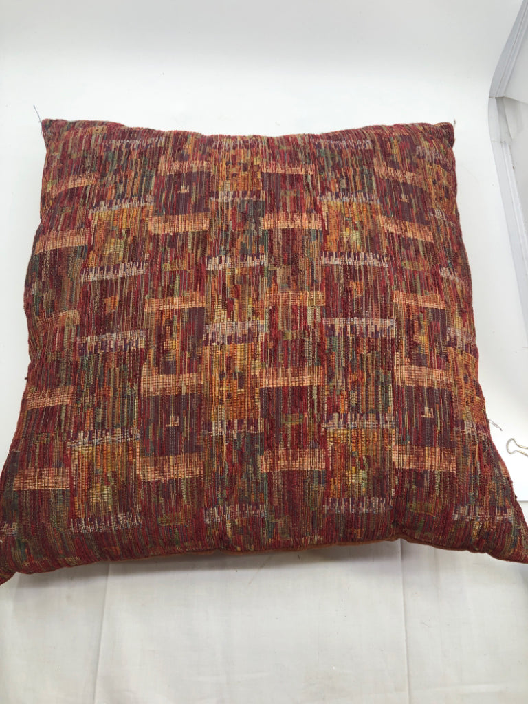 BURNT ORANGE PILLOW W COLORFUL PATTERN ACCENTS.
