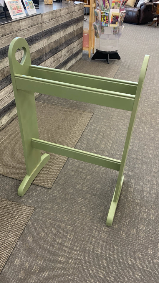 GREEN PAINTED QUILT RACK W/HEART CUTOUTS.