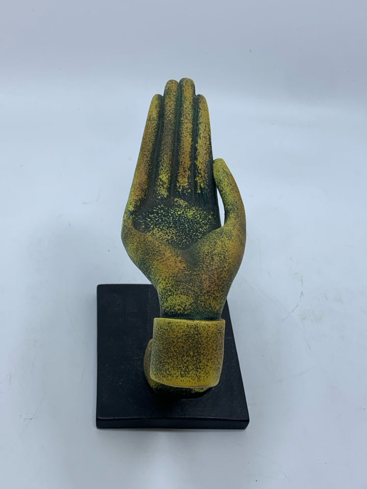 DISTRESSED GREEN AND GOLD HAND SCULPTURE ON BLACK BASE.