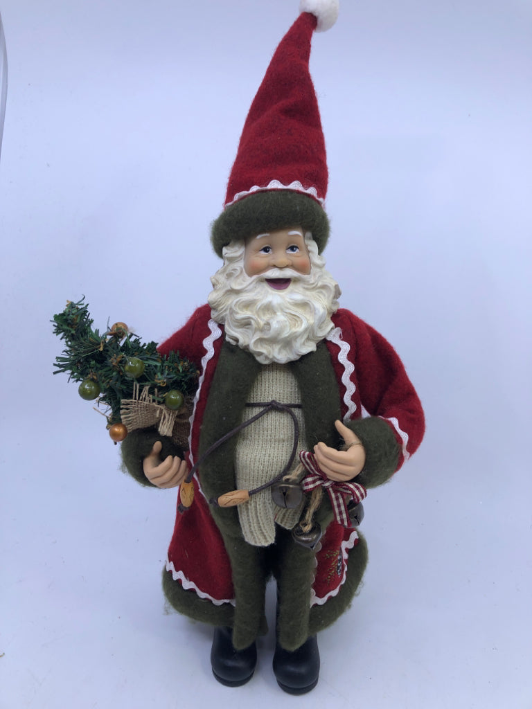 RESIN SANTA W/ RED COAT HOLDING CHRISTMAS TREE.