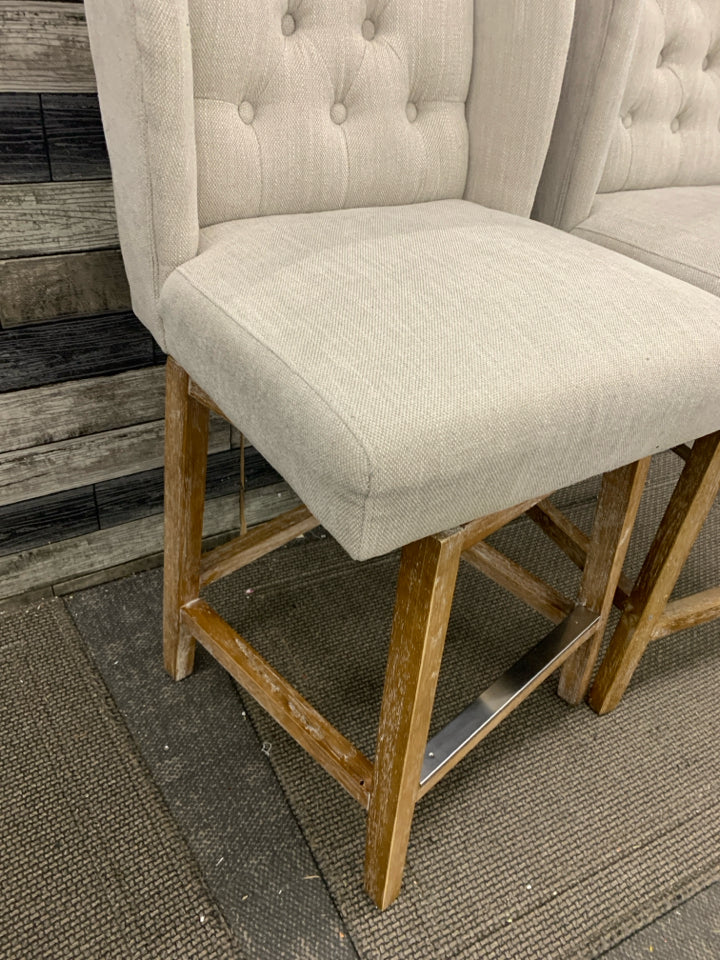 2 GRAY UPHOLSTERED SWIVEL CHAIRS.