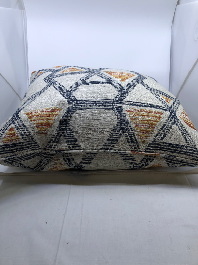 GREY ACCENT PILLOW W ORANGE AND NAVY BLUE ACCENTS.