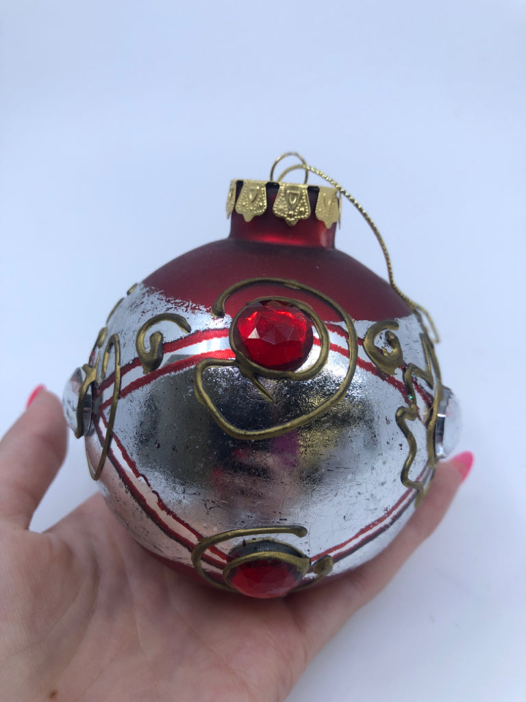 RED W/ SILVER BAND GLASS ORNAMENT W/ EMBOSSED JEWELS.