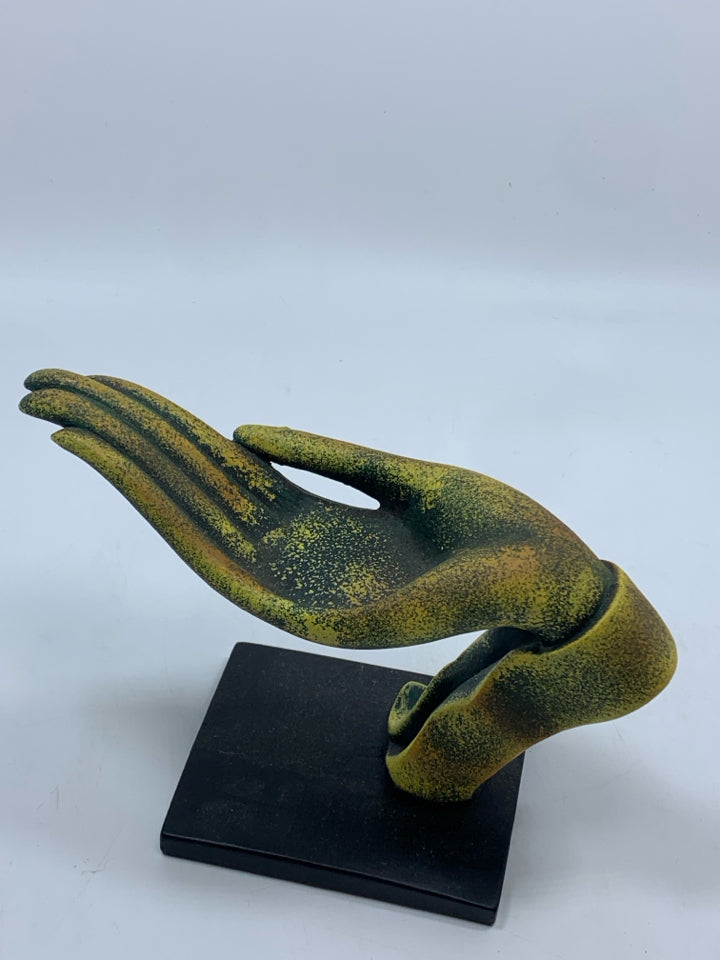 DISTRESSED GREEN AND GOLD HAND SCULPTURE ON BLACK BASE.