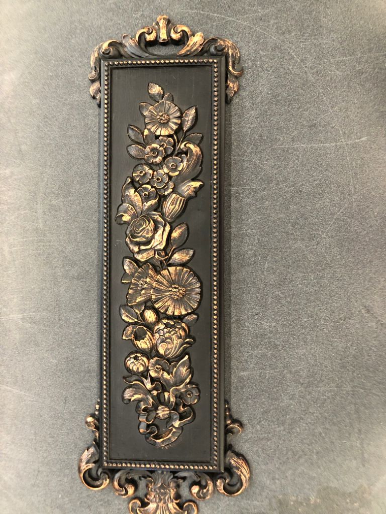 VTG BLACK W BRONZE FLORAL WALL HANGING.
