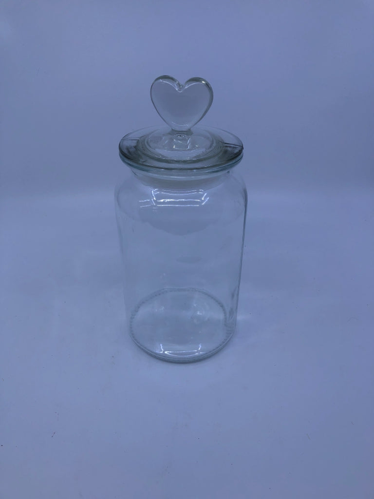 CLEAR GLASS CANISTER W/ HEART TOP HANDLE.
