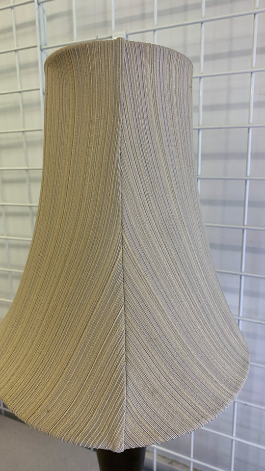 BRONZE BASE TABLE LAMP W/TAN TEXTURED STRIPE SHADE.