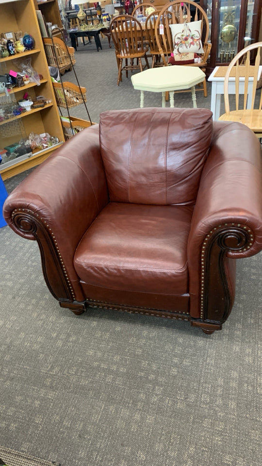 RED LEATHER CHAIR W/WOODEN UPHOLSTERY.