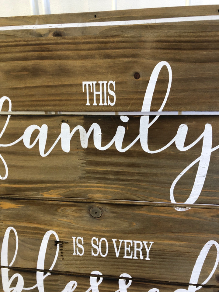 "THIS FAMILY" WHITE/WOOD WALL HANGING.