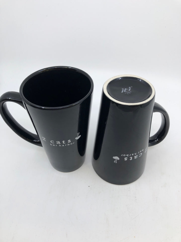 2 TALL BLACK AND WITE CAT MUGS.