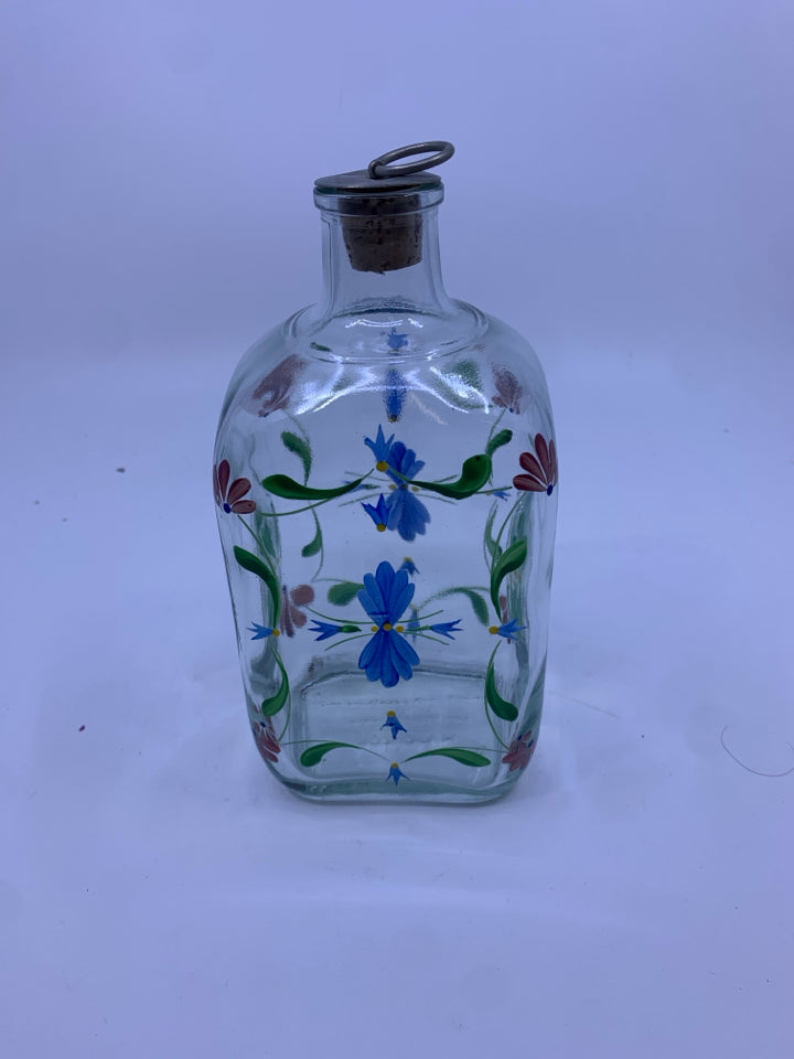 GLASS JAR WITH FLOWERS AND CORK STOPPER.
