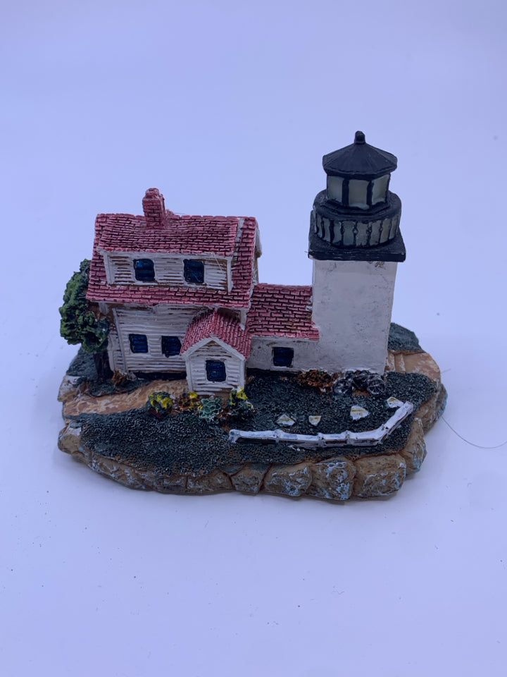 LARGE WHITE HOUSE WITH SQUARE ATTACHED LIGHT HOUSE.
