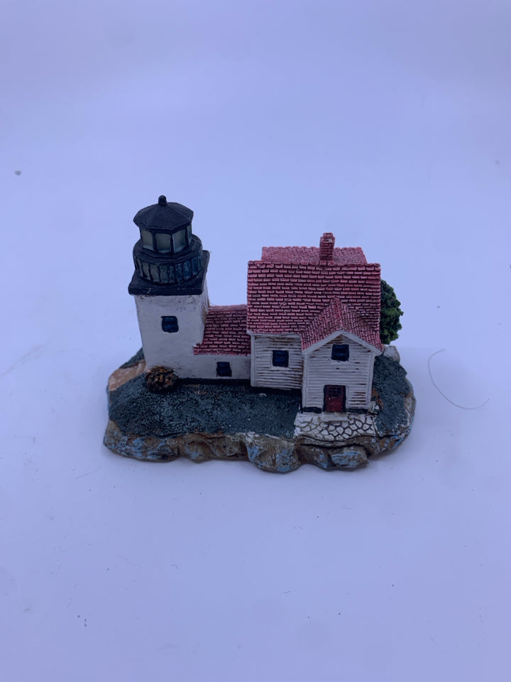 LARGE WHITE HOUSE WITH SQUARE ATTACHED LIGHT HOUSE.