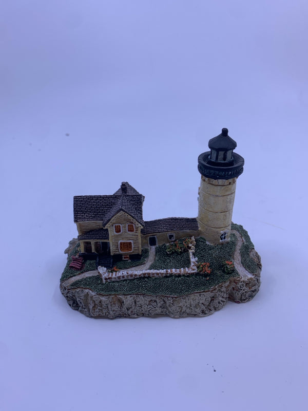 TAN HOUSE AND LIGHTHOUSE W/ BROWN ROOF.