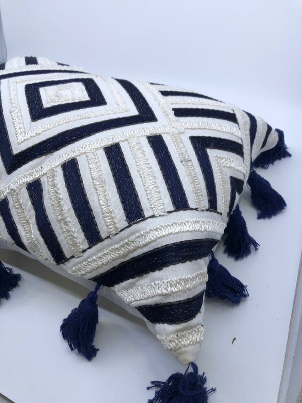 DARK BLUE AND WHITE DIAMOND PATTERN PILLOW WITH TASSELS.